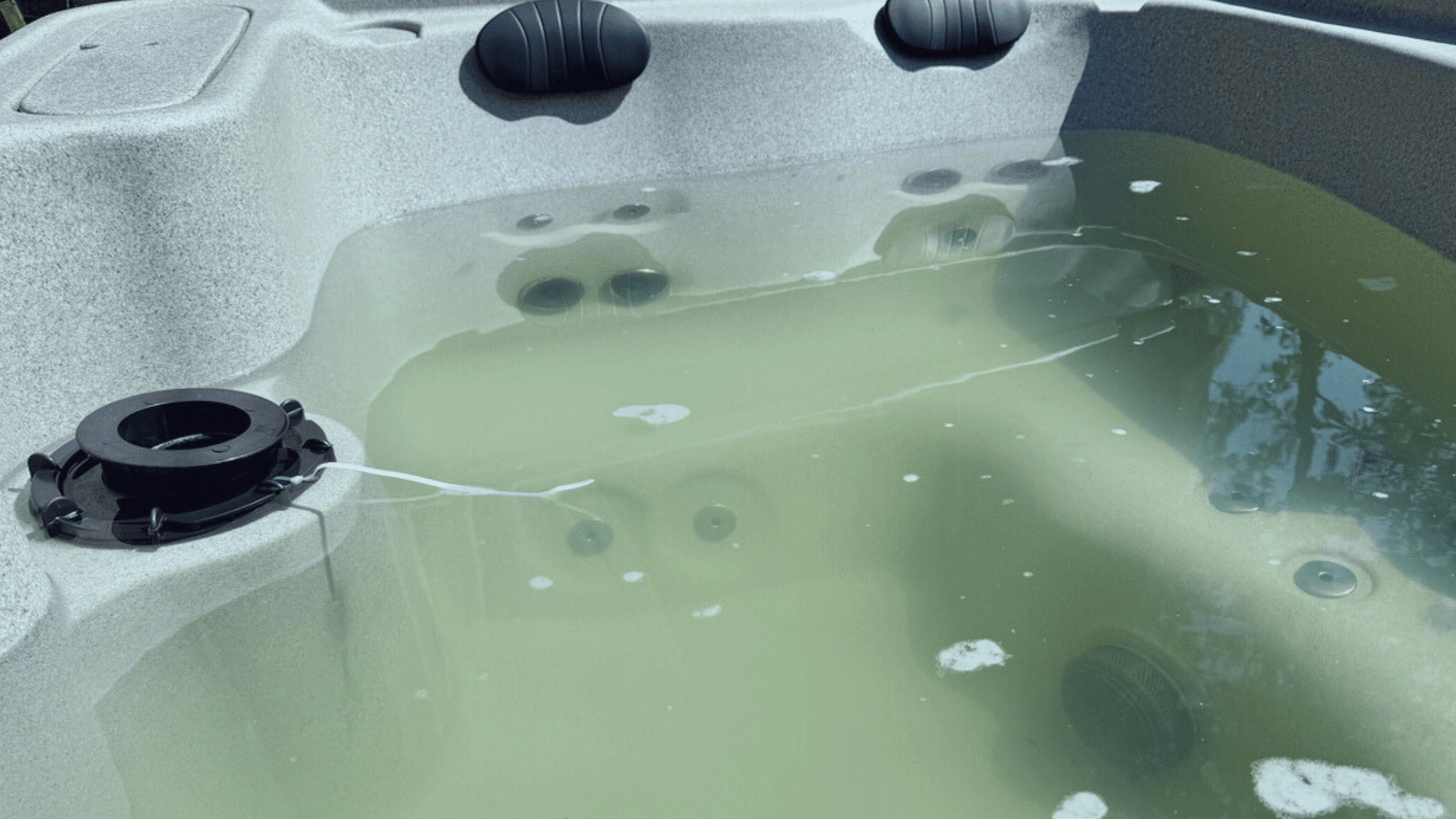 Hot tub on deck under blue sky near white vinyl fence. Cover is off after easy removal, showcasing hot tub cover options at Nejame & Sons in Danbury, CT & Carmel, NY.