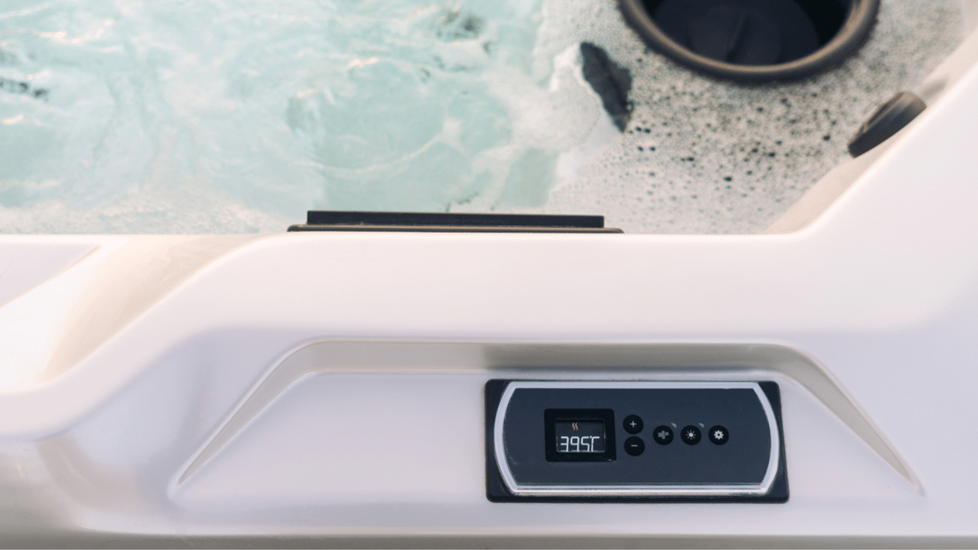 Hot tub on deck under blue sky near white vinyl fence. Cover is off after easy removal, showcasing hot tub cover options at Nejame & Sons in Danbury, CT & Carmel, NY.