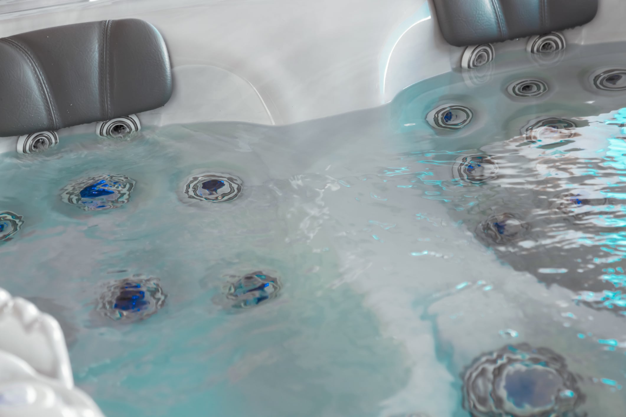 Two-person Sundance hot tub with bubbling water, showcasing family-friendly hot tubs for sale in New Fairfield, CT.