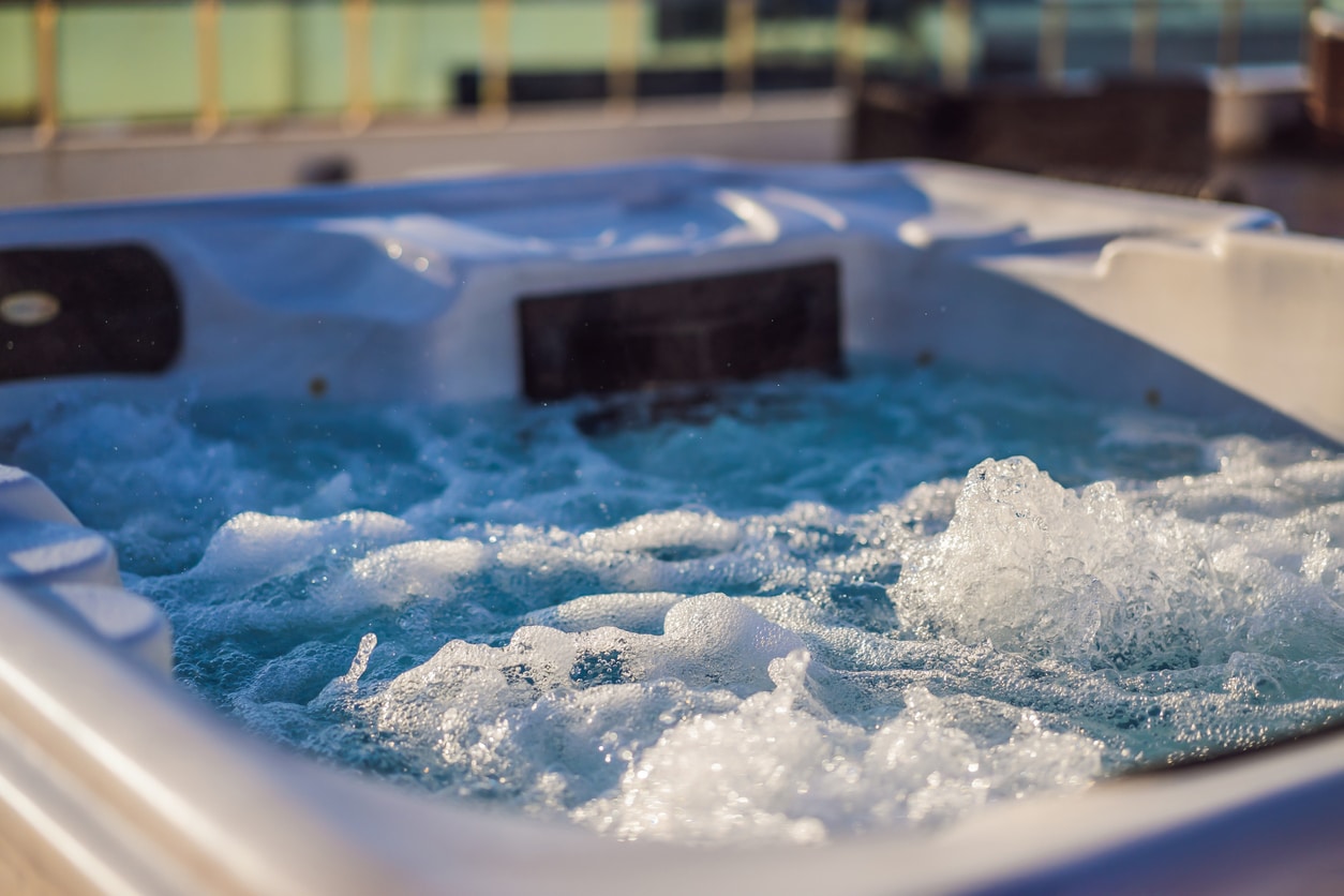 Close up of bubbling hyrdomassage hot tub with blue led lights, demonstrating one of many hot tub models available for sale in Carmel, NY.